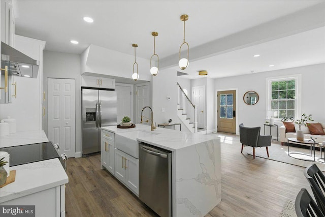 1705 Corwin Dr, Silver Spring, MD 20910 - kitchen featuring stainless steel appliances, wood finished floors, wall chimney range hood, recessed lighting, and pendant lighting