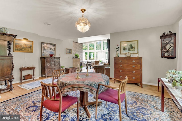 10135 Spring Pools Ln, Columbia, MD 21044 - dining area featuring a chandelier and light wood-style floors