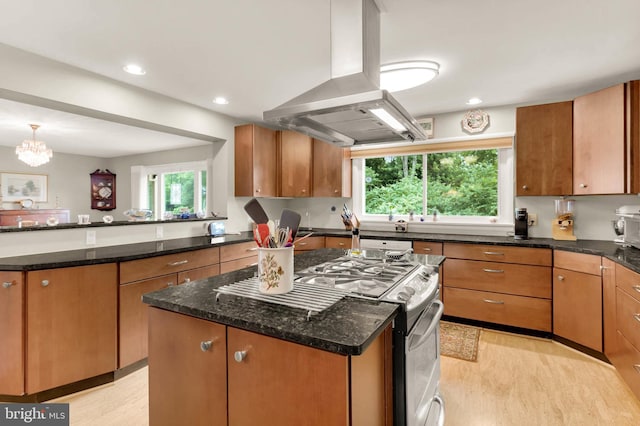 10135 Spring Pools Ln, Columbia, MD 21044 - kitchen featuring island range hood, stainless steel gas range, light wood finished floors, a kitchen island, and dark stone counters