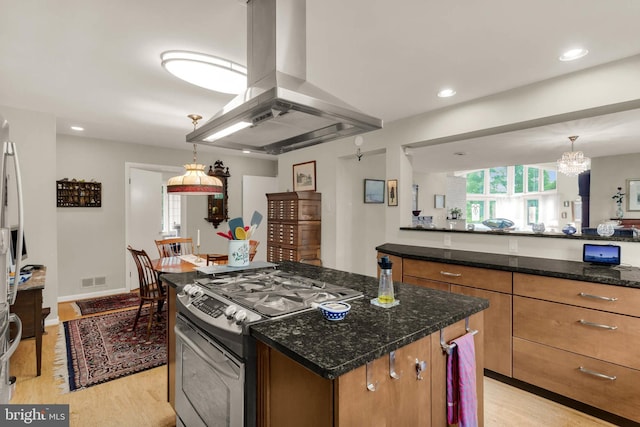 10135 Spring Pools Ln, Columbia, MD 21044 - kitchen featuring island exhaust hood, double oven range, light wood-style floors, brown cabinetry, and recessed lighting
