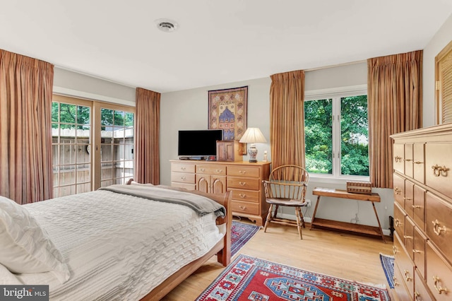 10135 Spring Pools Ln, Columbia, MD 21044 - bedroom with multiple windows, light wood-type flooring, and access to exterior