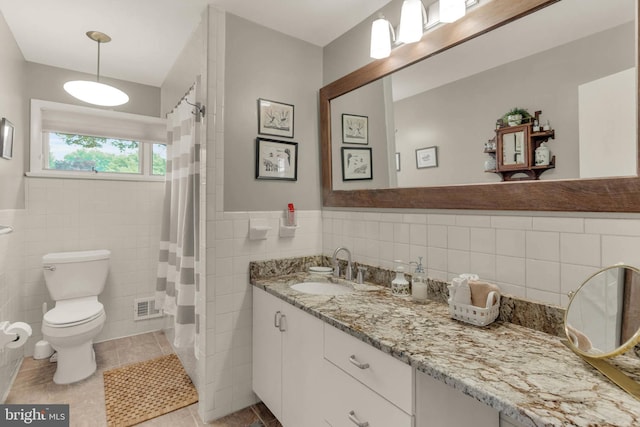 10135 Spring Pools Ln, Columbia, MD 21044 - full bathroom featuring tile walls, vanity, tile patterned floors, wainscoting, and a shower with shower curtain