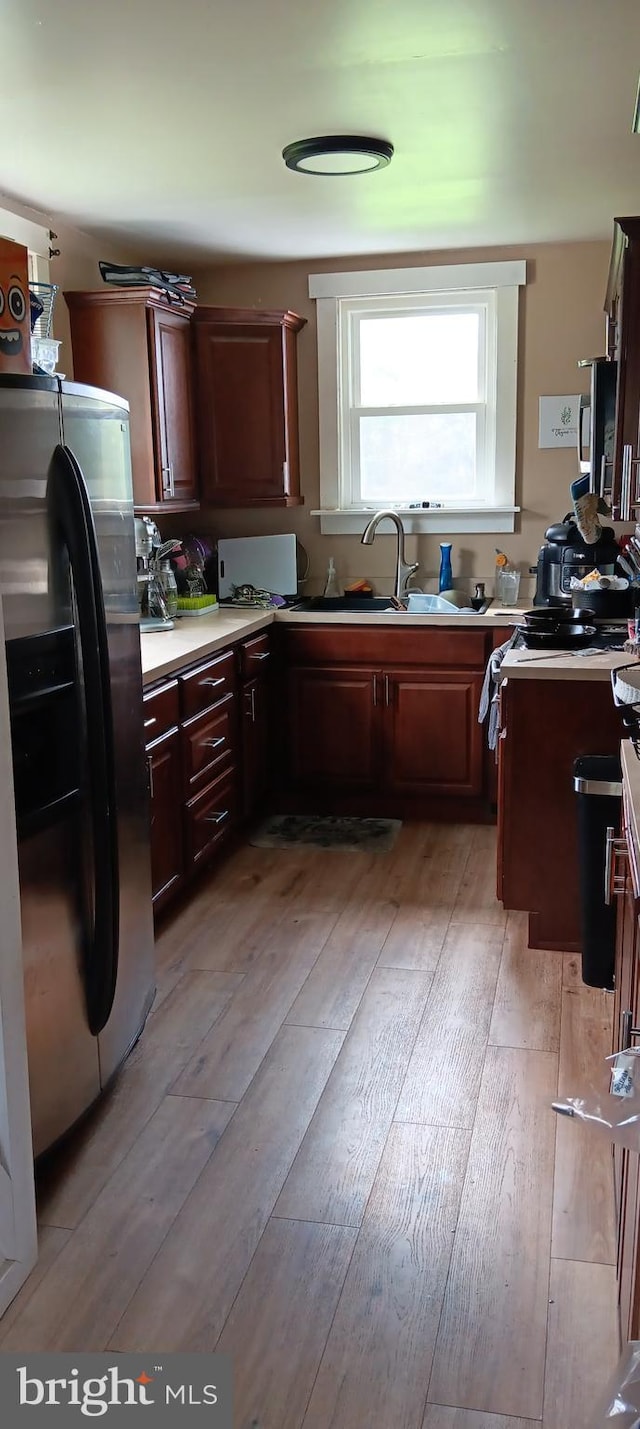 106 Center St, Manns Choice, PA 15550 - kitchen with stainless steel refrigerator with ice dispenser, light wood-style flooring, and light countertops