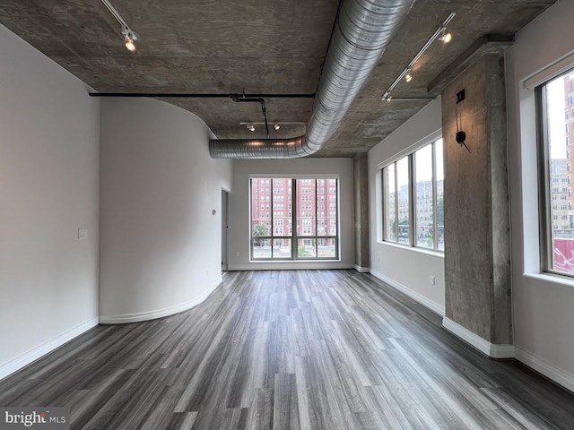 301 Massachusetts Ave NW Unit 301, Washington, DC 20001 - unfurnished room featuring rail lighting, wood finished floors, and plenty of natural light