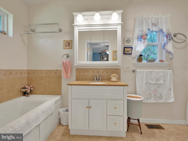 2528 Papoose Dr, Auburn, PA 17922 - bathroom with a garden tub, vanity, and decorative backsplash
