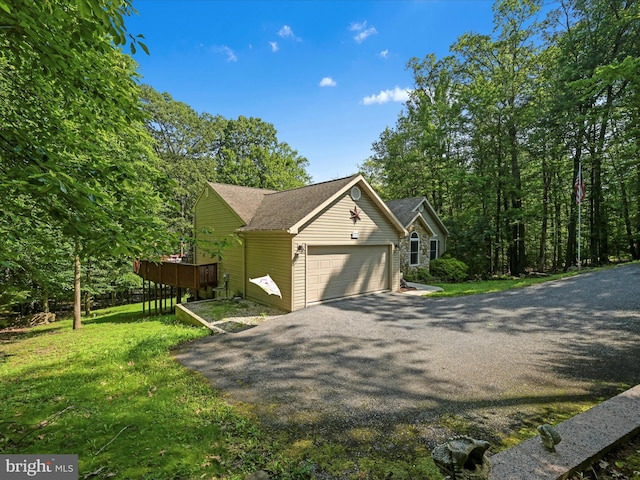 2528 Papoose Dr, Auburn, PA 17922 - view of side of home featuring a garage, asphalt driveway, and a lawn