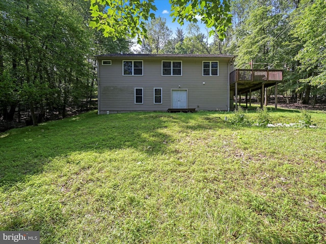 2528 Papoose Dr, Auburn, PA 17922 - rear view of house with a deck, a yard, and view of scattered trees