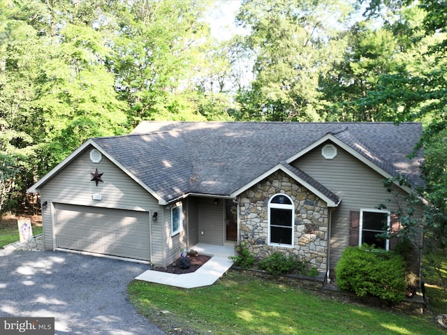 2528 Papoose Dr, Auburn, PA 17922 - view of front of house featuring a shingled roof, an attached garage, asphalt driveway, and stone siding
