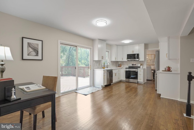 1429 Valley Mill Ct, Herndon, VA 20170 - kitchen with stainless steel appliances, light countertops, decorative backsplash, white cabinets, and dark wood-style flooring