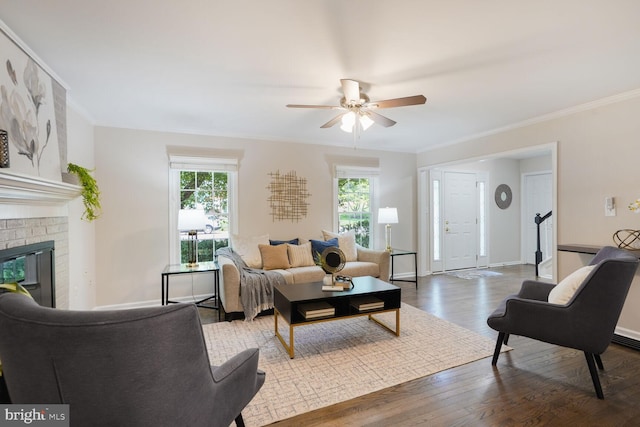 1429 Valley Mill Ct, Herndon, VA 20170 - living area featuring healthy amount of natural light, a ceiling fan, wood finished floors, a fireplace, and ornamental molding