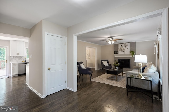 1429 Valley Mill Ct, Herndon, VA 20170 - living room with dark wood finished floors, a ceiling fan, a brick fireplace, and crown molding