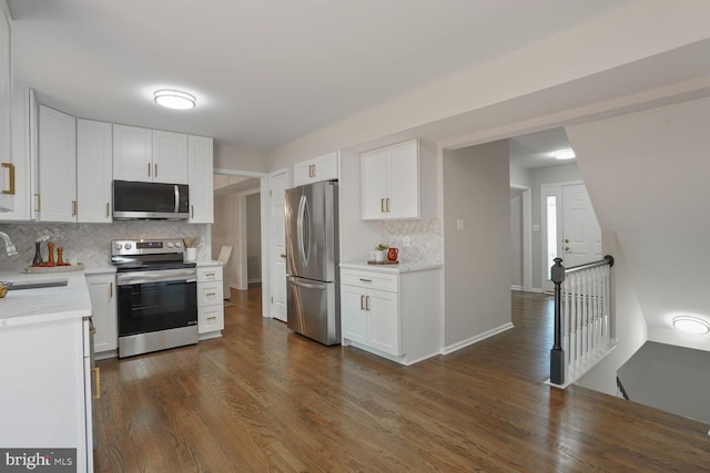 1429 Valley Mill Ct, Herndon, VA 20170 - kitchen featuring stainless steel appliances, backsplash, white cabinetry, and dark wood-style flooring