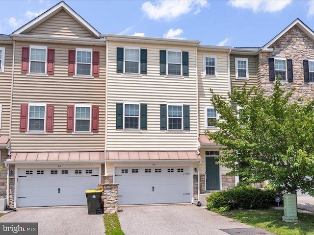44 Munro Rd, Newark, DE 19711 - townhome / multi-family property with stone siding, driveway, and a garage