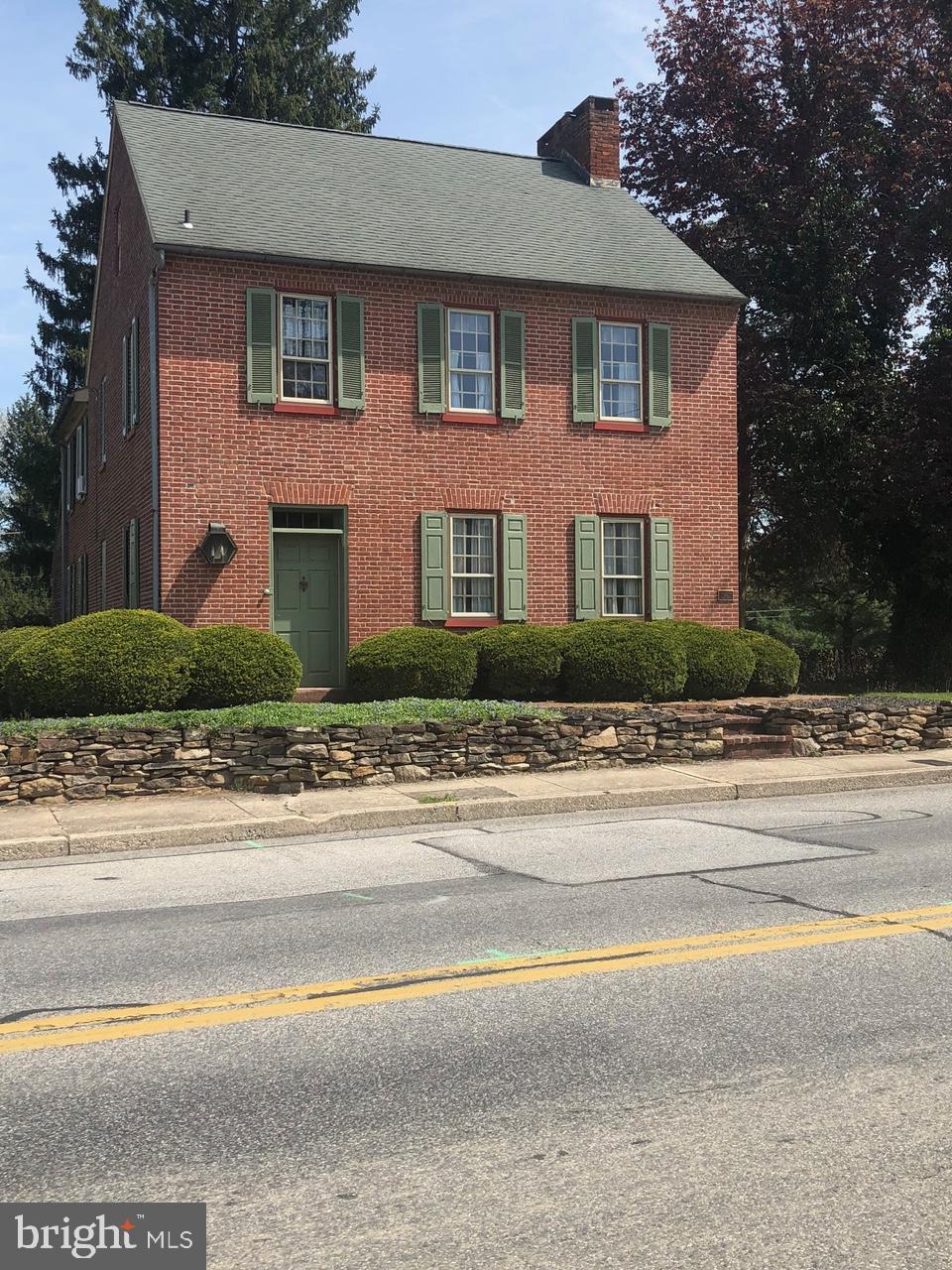 206 E King St, East Berlin, PA 17316 - colonial-style house featuring a chimney, brick siding, and a shingled roof