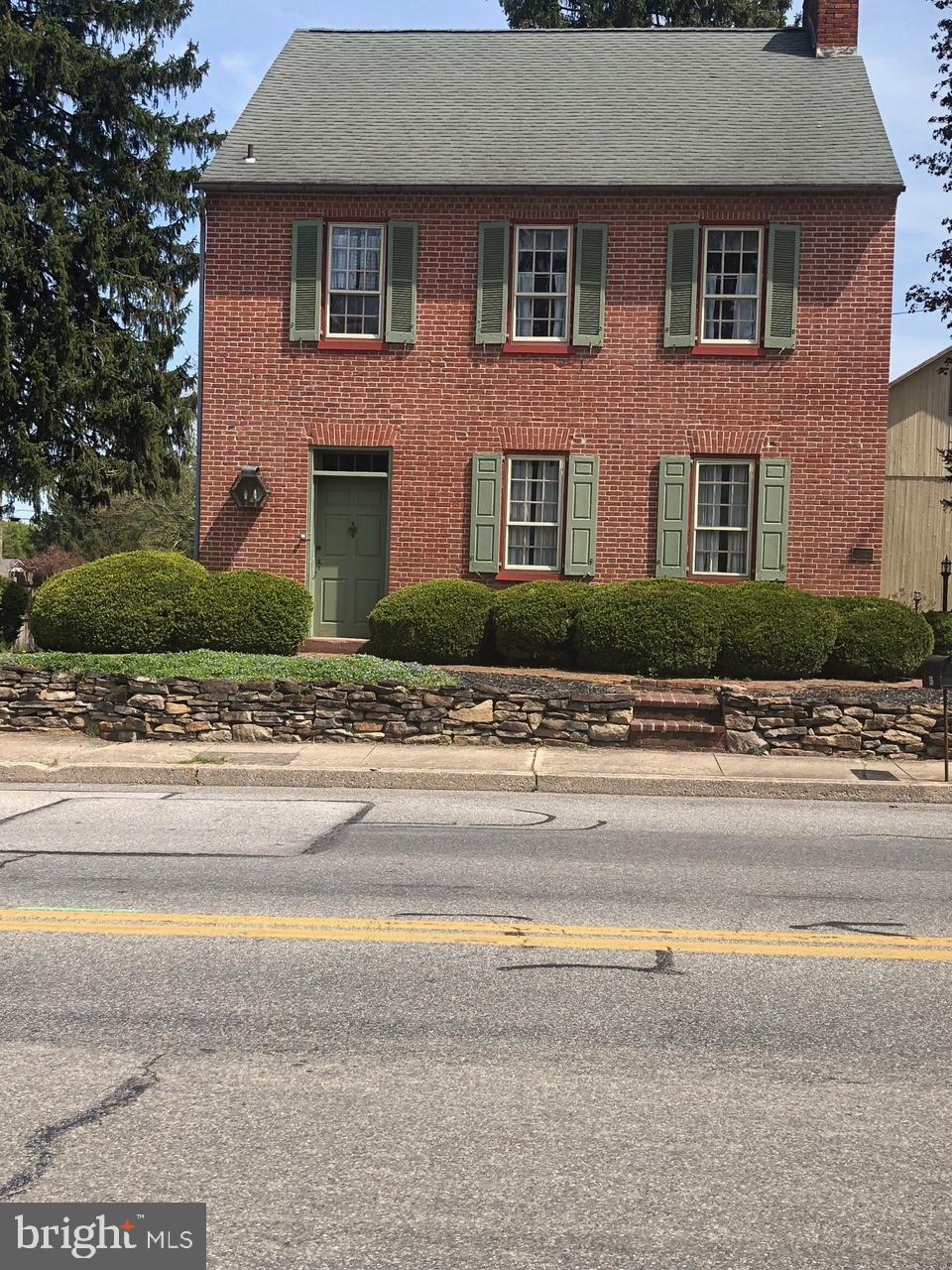 206 E King St, East Berlin, PA 17316 - colonial-style house with a chimney, brick siding, and a shingled roof
