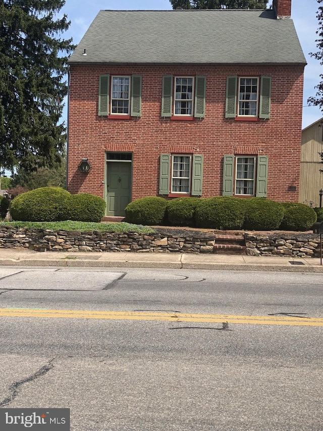 206 E King St, East Berlin, PA 17316 - colonial-style house with a chimney, brick siding, and a shingled roof