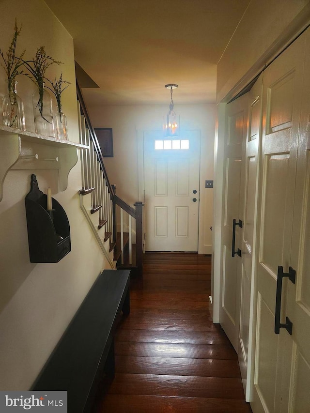 2569 White Oak Rd, Strasburg, PA 17579 - entryway featuring dark wood-style flooring, stairs, and a chandelier