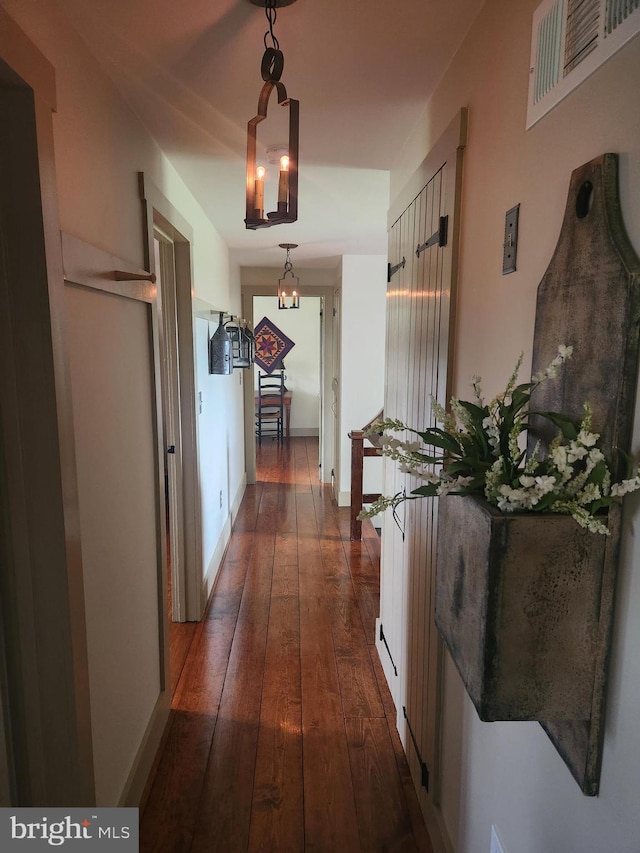2569 White Oak Rd, Strasburg, PA 17579 - hall featuring dark wood-type flooring and a chandelier