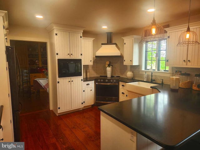 2569 White Oak Rd, Strasburg, PA 17579 - kitchen featuring stainless steel gas stove, black microwave, custom range hood, dark countertops, and dark wood-style floors