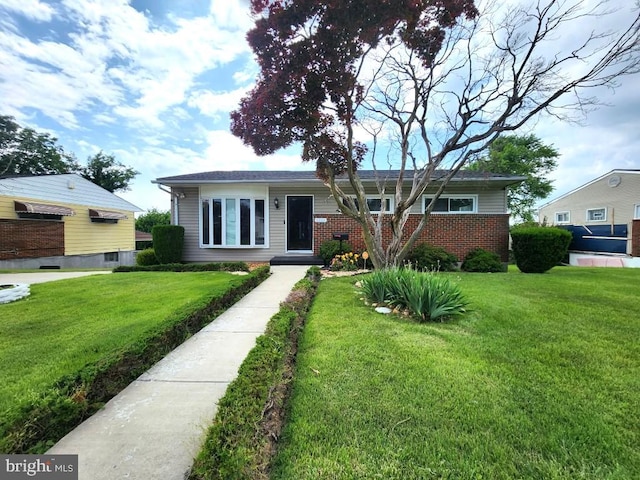 6222 Catalpha Rd, Baltimore, MD 21214 - view of front of home featuring a front yard and brick siding