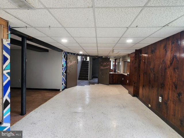 6222 Catalpha Rd, Baltimore, MD 21214 - finished below grade area with stairway, a paneled ceiling, wooden walls, and recessed lighting
