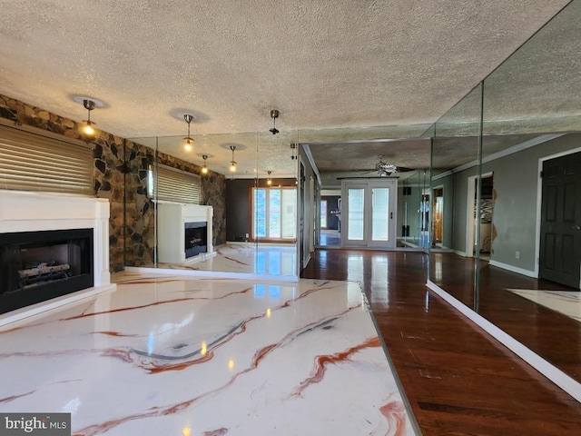 6222 Catalpha Rd, Baltimore, MD 21214 - unfurnished living room with a fireplace, a textured ceiling, and wood finished floors