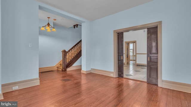 501 W 4th St, Bethlehem, PA 18015 - unfurnished room featuring a chandelier, wood-type flooring, and stairway