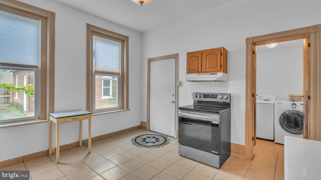 501 W 4th St, Bethlehem, PA 18015 - kitchen featuring stainless steel electric range, under cabinet range hood, light tile patterned flooring, separate washer and dryer, and light countertops