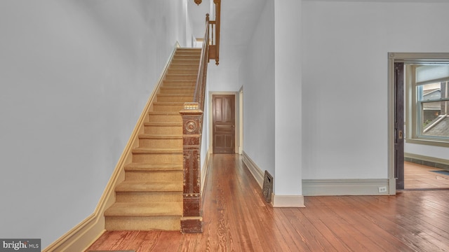 501 W 4th St, Bethlehem, PA 18015 - staircase with hardwood / wood-style flooring and a towering ceiling