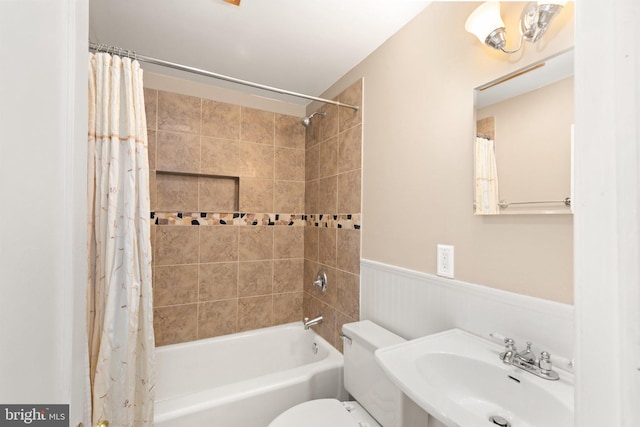 2216 Gaylawn Dr, Halethorpe, MD 21227 - bathroom featuring shower / tub combo and a wainscoted wall