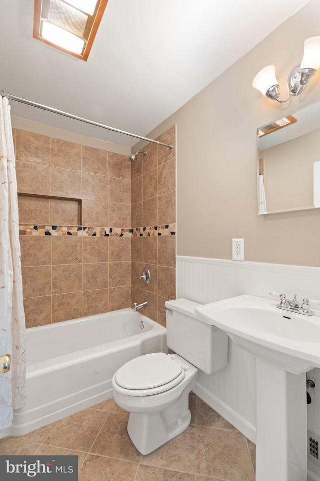2216 Gaylawn Dr, Halethorpe, MD 21227 - bathroom with shower / tub combo with curtain, tile patterned floors, and wainscoting