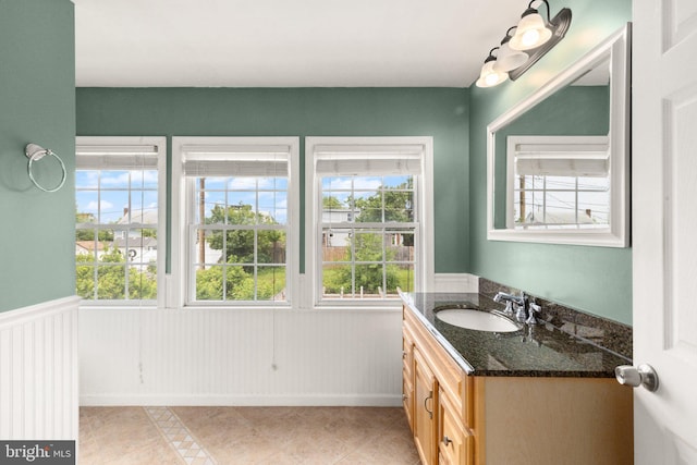 2216 Gaylawn Dr, Halethorpe, MD 21227 - bathroom featuring vanity, a wainscoted wall, and tile patterned floors