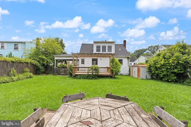 2216 Gaylawn Dr, Halethorpe, MD 21227 - back of house with a storage unit, a wooden deck, a fenced backyard, a chimney, and outdoor dining area