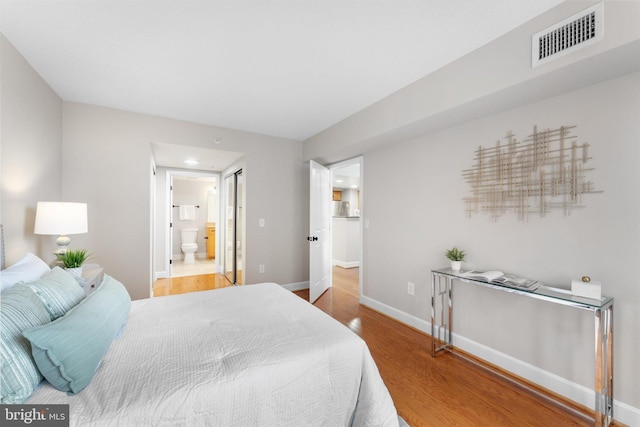 1205 N Garfield St Unit 711, Arlington, VA 22201 - bedroom with wood finished floors, ensuite bathroom, and recessed lighting
