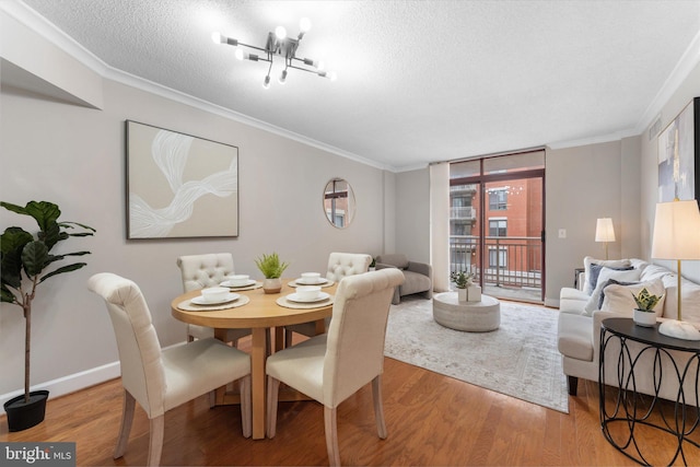 1205 N Garfield St Unit 711, Arlington, VA 22201 - dining space featuring wood finished floors, crown molding, a textured ceiling, and a chandelier