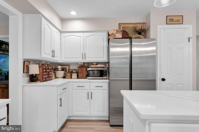 12513 Dardanelle Ct, Herndon, VA 20170 - kitchen with appliances with stainless steel finishes, white cabinets, light wood-type flooring, light stone countertops, and recessed lighting