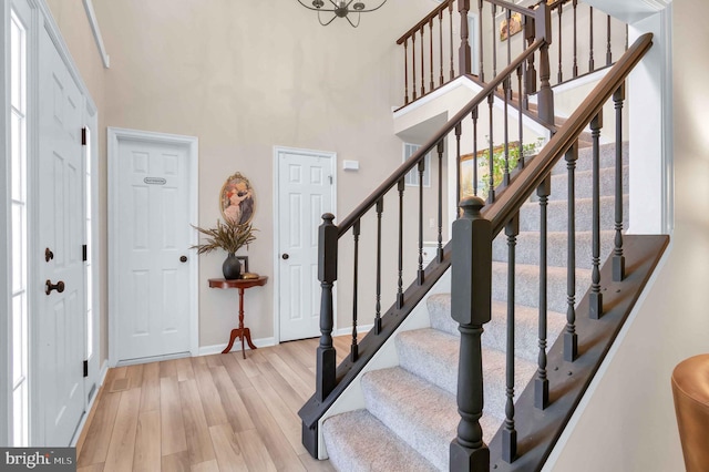 12513 Dardanelle Ct, Herndon, VA 20170 - entrance foyer with light wood-type flooring, stairway, and a high ceiling