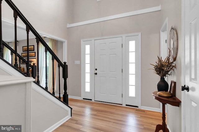 12513 Dardanelle Ct, Herndon, VA 20170 - foyer with light wood finished floors, stairway, and a towering ceiling