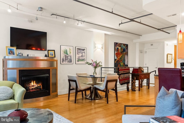 2328 Champlain St NW Unit 101, Washington, DC 20009 - dining area featuring light wood finished floors and a warm lit fireplace