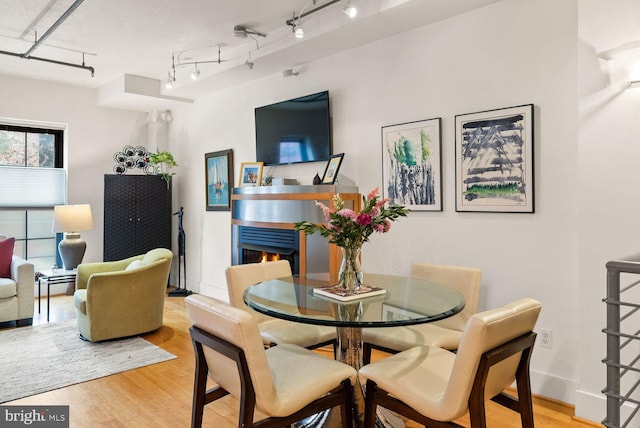 2328 Champlain St NW Unit 101, Washington, DC 20009 - dining area with wood finished floors and a warm lit fireplace