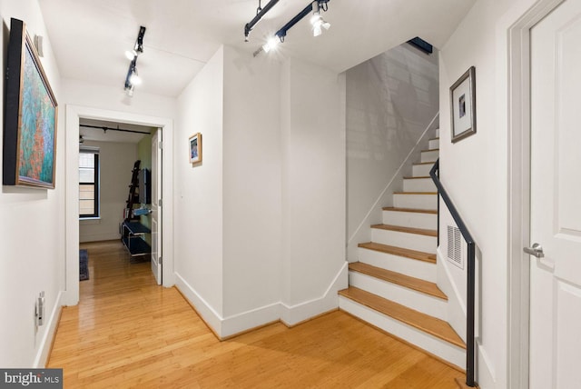 2328 Champlain St NW Unit 101, Washington, DC 20009 - hallway with rail lighting, light wood-type flooring, and stairs