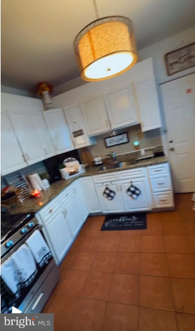 2541 N 5th St, Philadelphia, PA 19133 - kitchen with dark tile patterned flooring and white cabinets