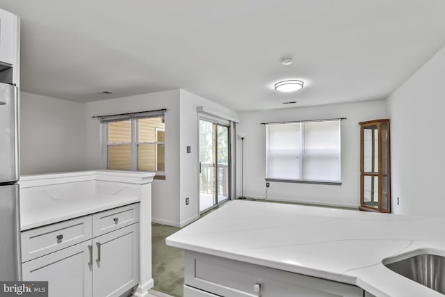 20 Deer Run Ct Unit D, Baltimore, MD 21227 - kitchen featuring freestanding refrigerator and light stone counters