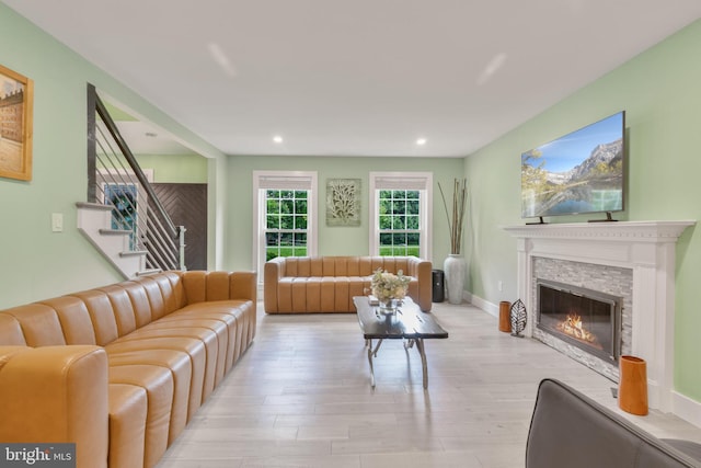 11726 Lariat Ln, Oakton, VA 22124 - living room featuring light wood-style floors, recessed lighting, a glass covered fireplace, and stairway