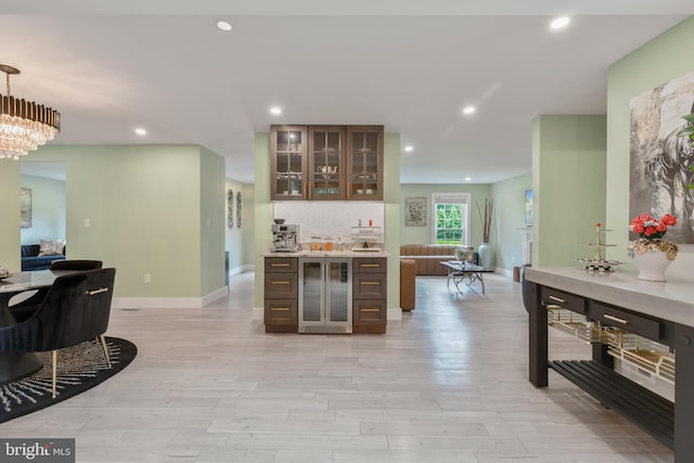 11726 Lariat Ln, Oakton, VA 22124 - bar area with wine cooler, light wood finished floors, recessed lighting, pendant lighting, and a chandelier