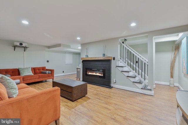 11726 Lariat Ln, Oakton, VA 22124 - living area featuring light wood-type flooring, a glass covered fireplace, recessed lighting, and stairs