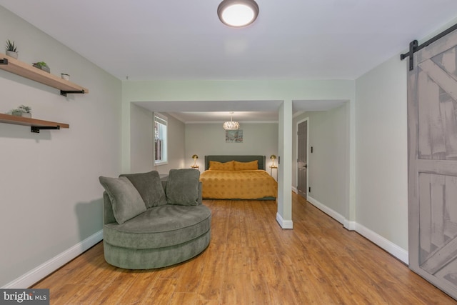 11726 Lariat Ln, Oakton, VA 22124 - bedroom with a barn door and wood finished floors
