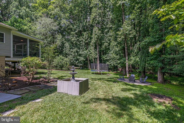 11726 Lariat Ln, Oakton, VA 22124 - view of grassy yard with a trampoline, a sunroom, and a fire pit