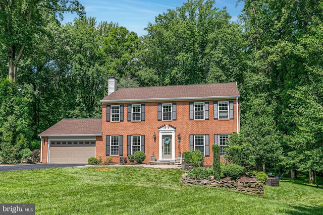 11726 Lariat Ln, Oakton, VA 22124 - colonial home featuring brick siding, driveway, a chimney, a garage, and a front lawn