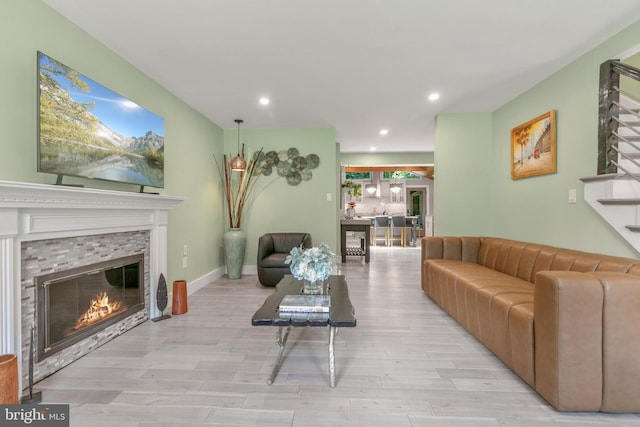 11726 Lariat Ln, Oakton, VA 22124 - living room featuring a glass covered fireplace, light wood-style floors, recessed lighting, and stairway